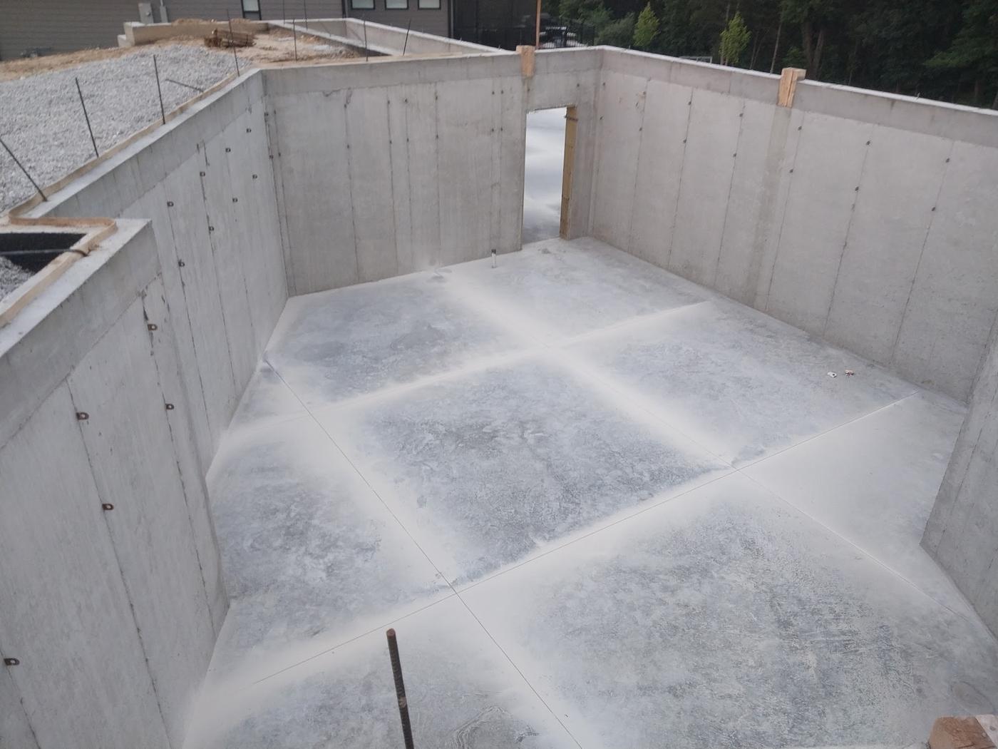 Poured walls, and a floor troweled flat and scored into panels so it cracks where it is told to.
